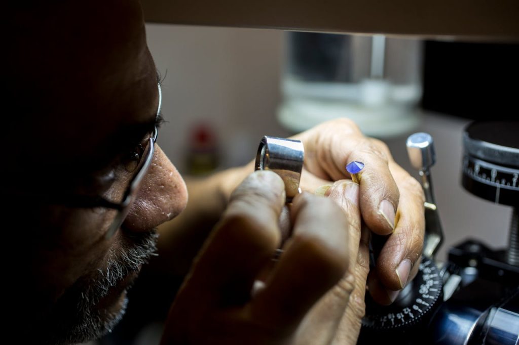 Close-up of a jeweler inspecting a gemstone in Dubai, highlighting precision and craftsmanship.